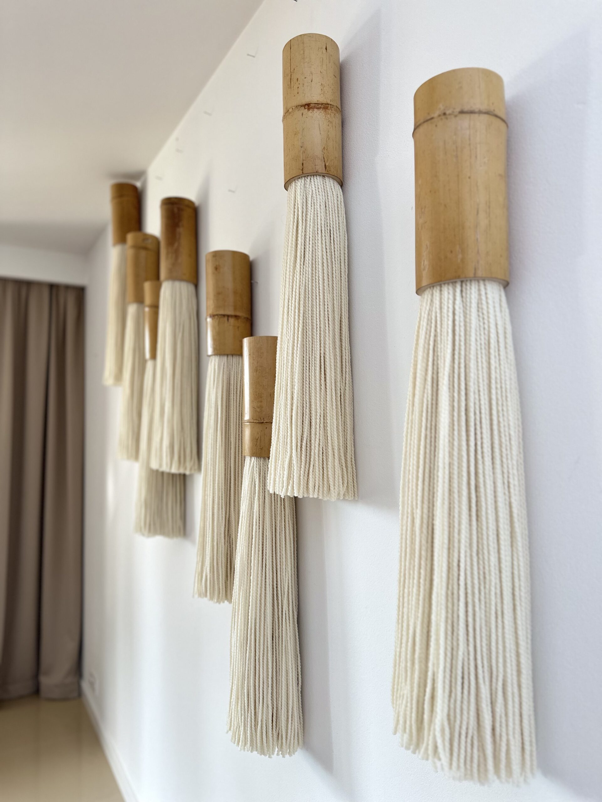 Handcrafted bamboo and wool fiber art wall module detail, natural materials