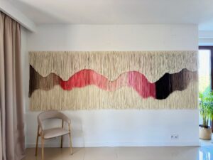 large-scale wool fiber art wall hanging installation in contemporary interior