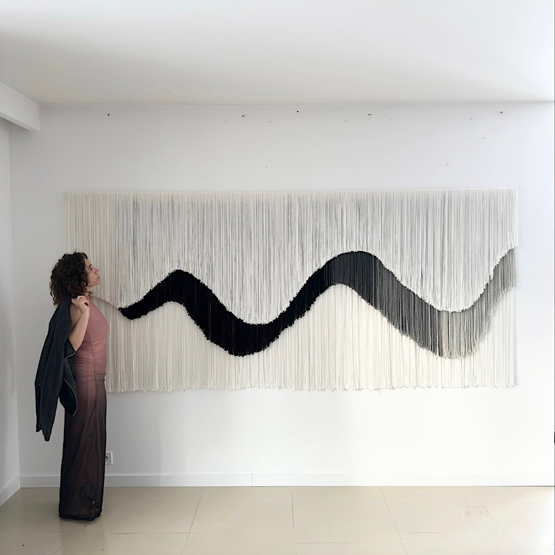 Large-scale wool fiber art wall installation in a modern interior