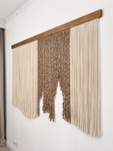 Luxury fiber art close up, handcrafted alpaca wool and jute wall hanging, rich texture and natural materials.