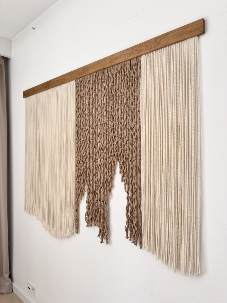 Luxury fiber art close up, handcrafted alpaca wool and jute wall hanging, rich texture and natural materials.