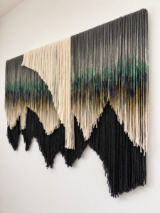 Modern fiber art wall hanging handcrafted from hand-dyed alpaca and sheep wool, statement textile decor for upscale contemporary homes and designer interiors.