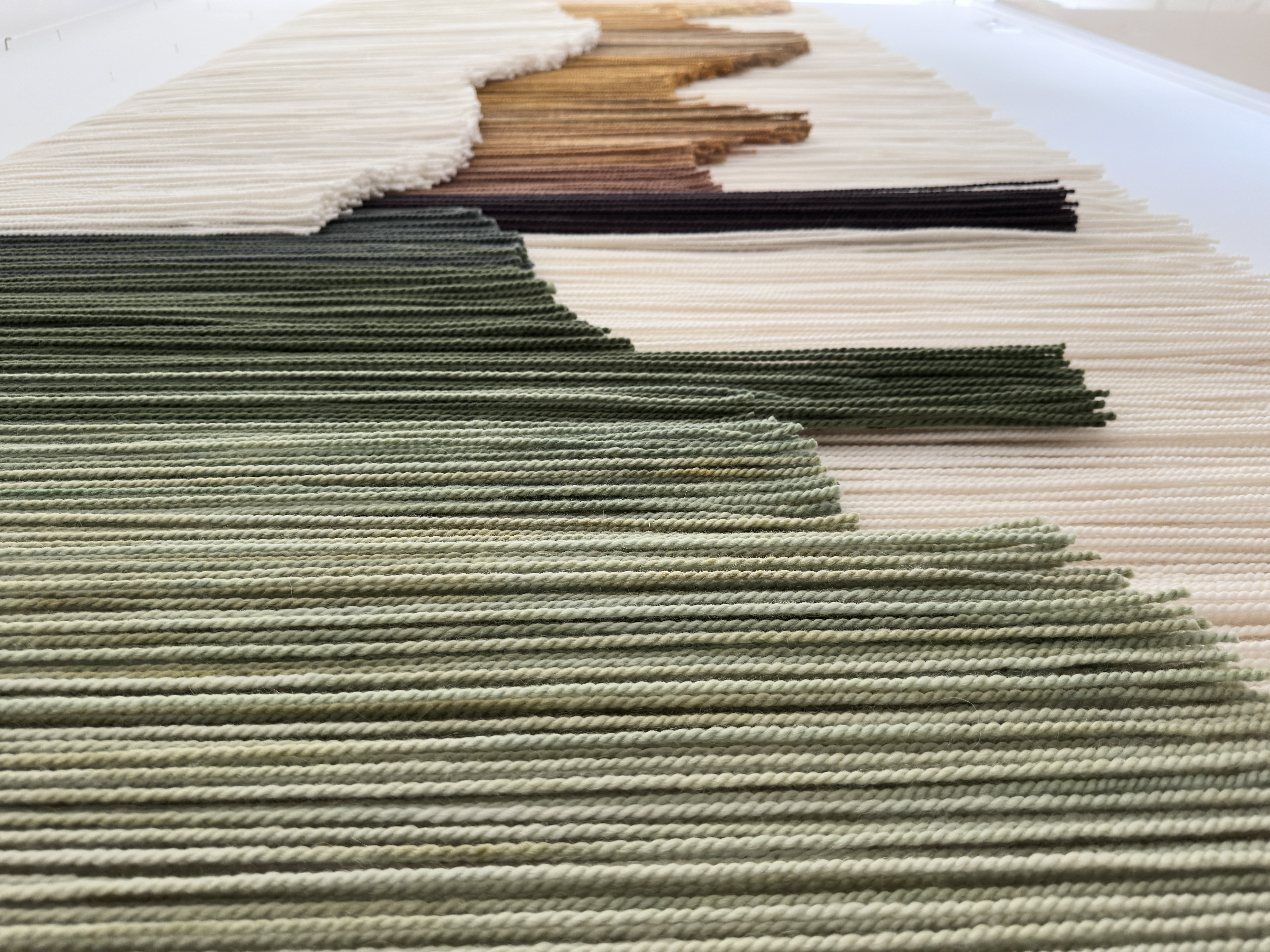Contemporary handmade tapestry created from premium alpaca wool fibers, oversized neutral wall art for designer interiors, organic modern luxury home styling.